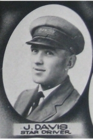 A uniformed driver smiles for the camera in 1925